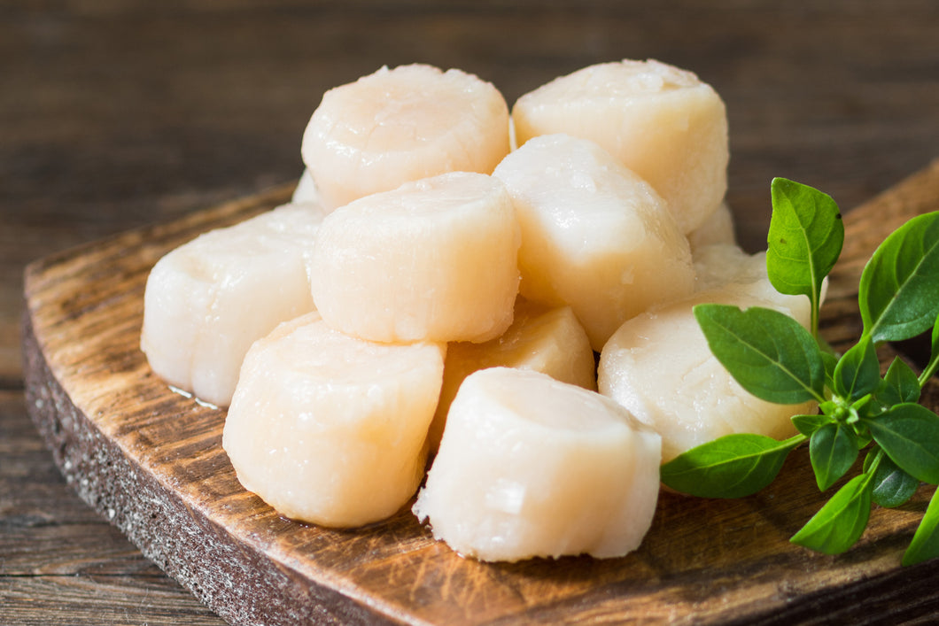 Sea Scallops on a wooden paddle