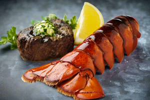 Lobster with filet mignon and lemon wedge